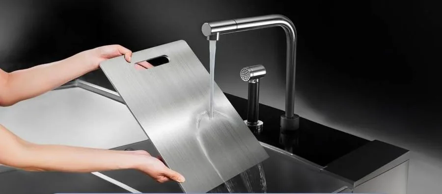 Titanium cutting board being washed under running water